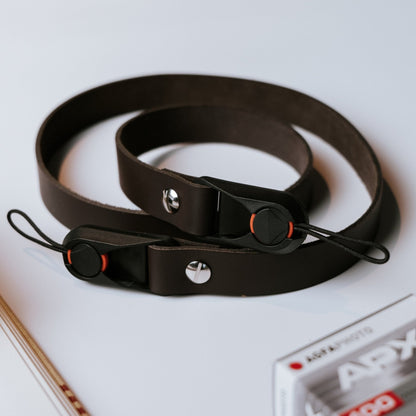Quick release black leather camera strap with vintage design and adjustable length for DSLR and analog cameras